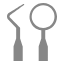 Two dental instruments - mirror and explorer - used in endodontic examination procedures.